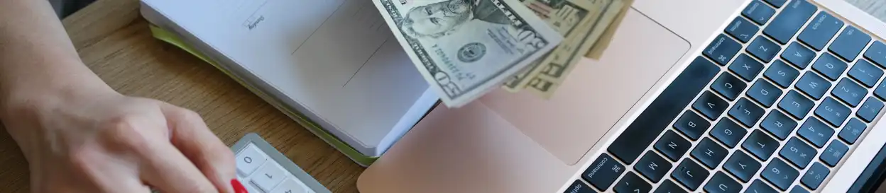 Cash, a calculator and a computer keyboard