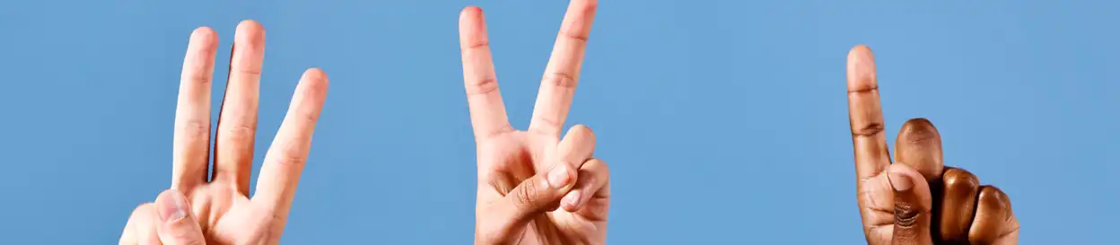 three hands: one holding up three fingers, another making a 'peace' sign, and another pointing with their index finger