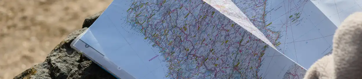 a first-person perspective of a map of portugal, resting on a rock