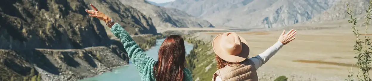 Two tourists look at a mountain