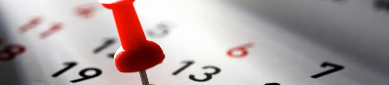 A red pin marks a date on a calendar