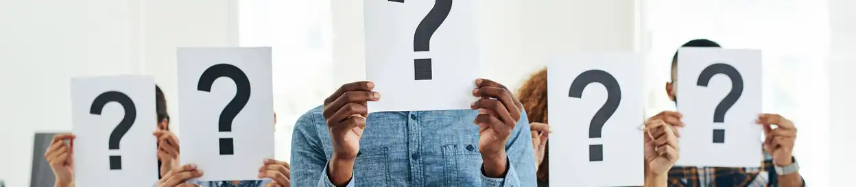 Five people holding sheets of paper with question marks in front of their faces