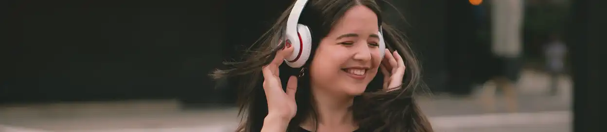 A young woman enjoying the music playing on her headphones