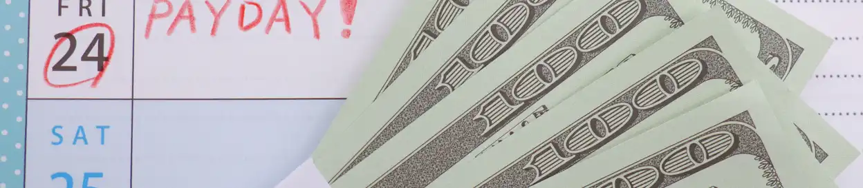 Cash and a calendar marked "payday!"