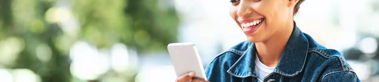 A young woman plays a game on her phone
