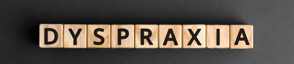 Wooden blocks spelling out the word "dyspraxia"