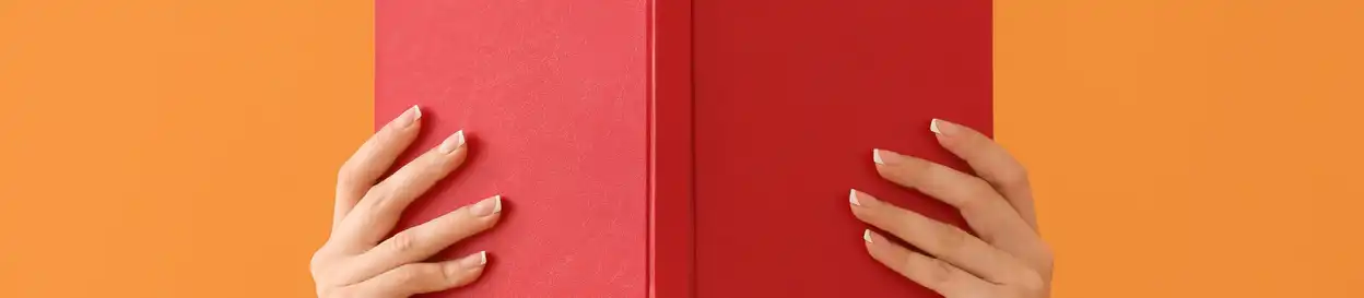 two hands holding a hardback book