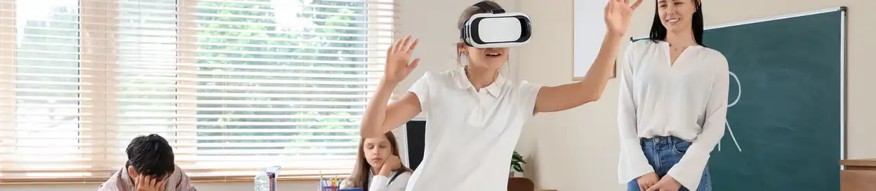 A young learner plays with a VR headset in a classroom