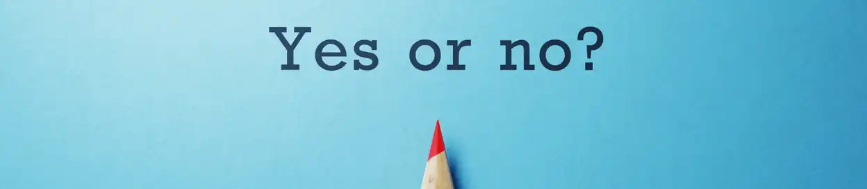 A sheet of paper that says "yes or no?" with a pencil visible towards the bottom of the image