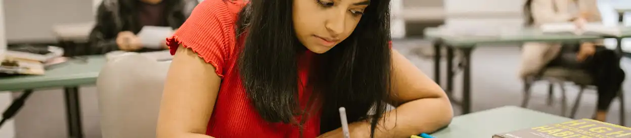 a young woman completes an exam