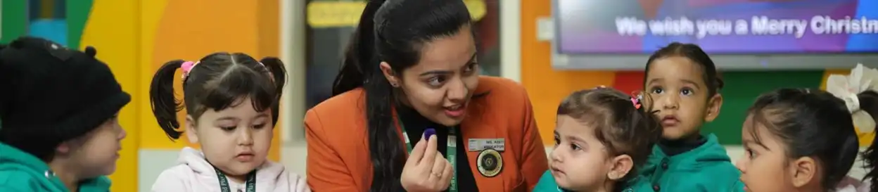 A teacher speaking to young pupils