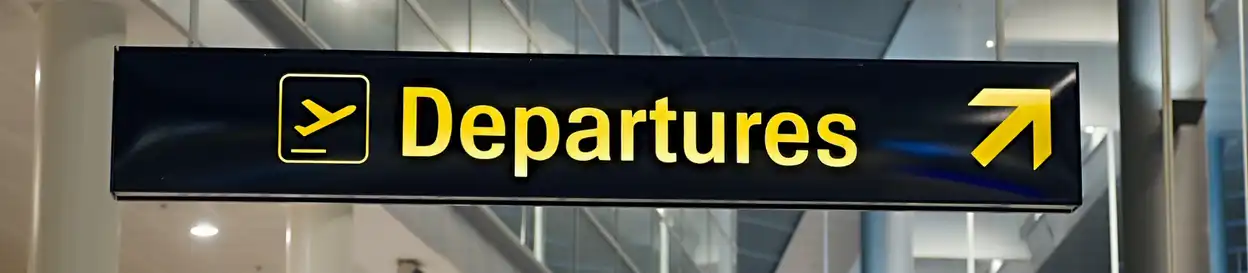 A sign that reads "Departures" at an airport