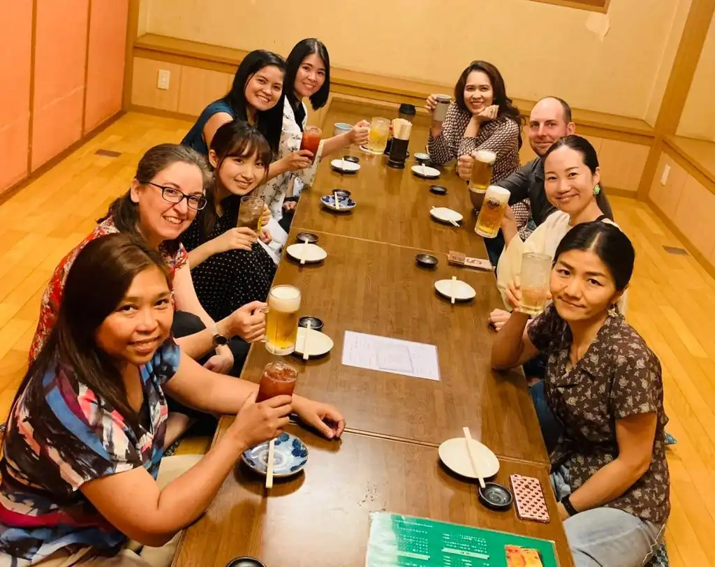 Men and women gathered around a table in Japan