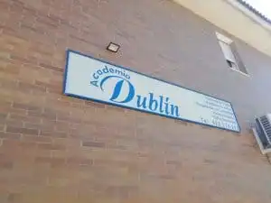 A sign on a building that says 'Academia Dublin' 