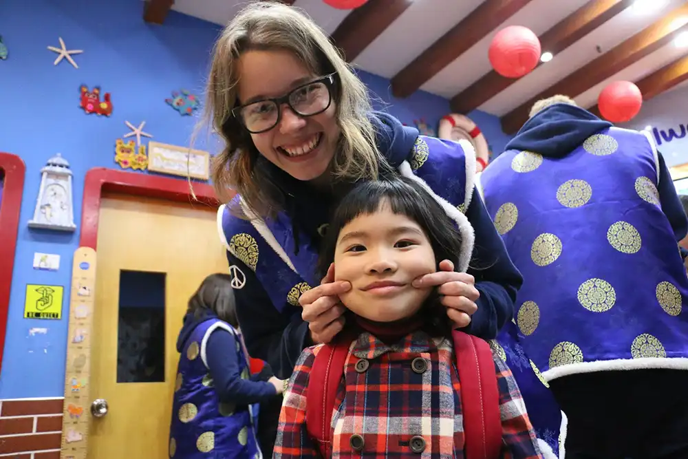 Teacher Ellie with a young student