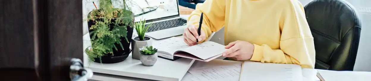 A woman writing in a notebook