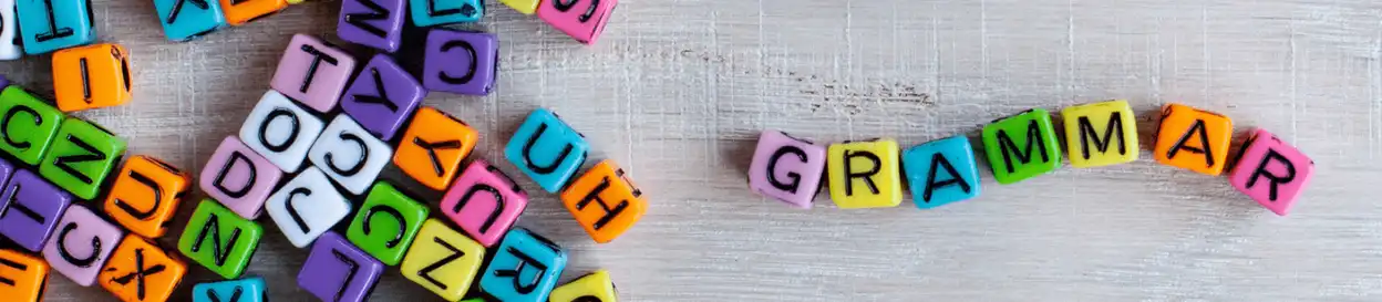 Beads with letters spelling out the word 'grammar'
