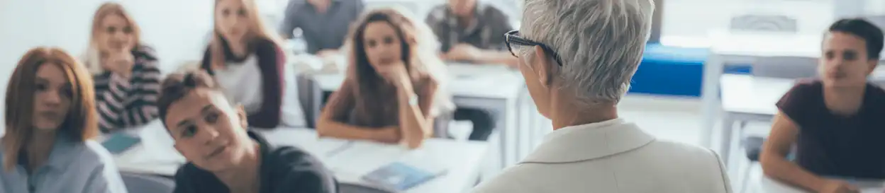 An older teacher leading a class