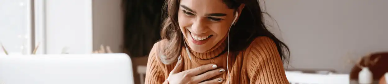 A smiling woman on a video call