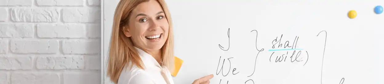 A female teacher standing in front of a whiteboard