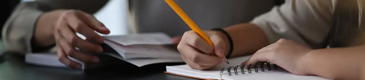 A person writing in a notebookd