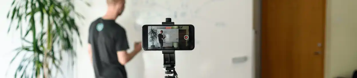 Male teacher recording a lesson via a phone