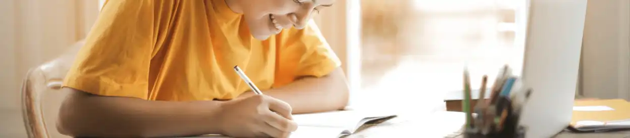 A woman in a yellow t-shirt studying