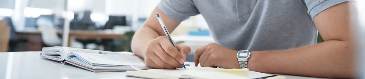 A man writing in a notebook