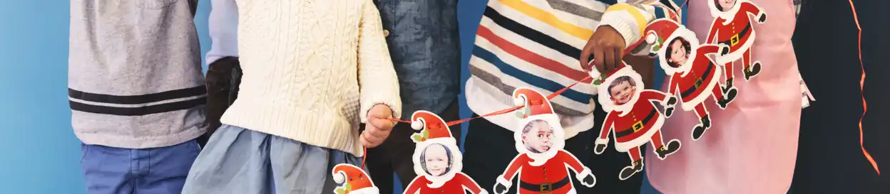 Children holding a banner of santas