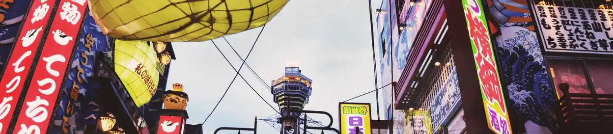 A Japanese street lit up with neon lights