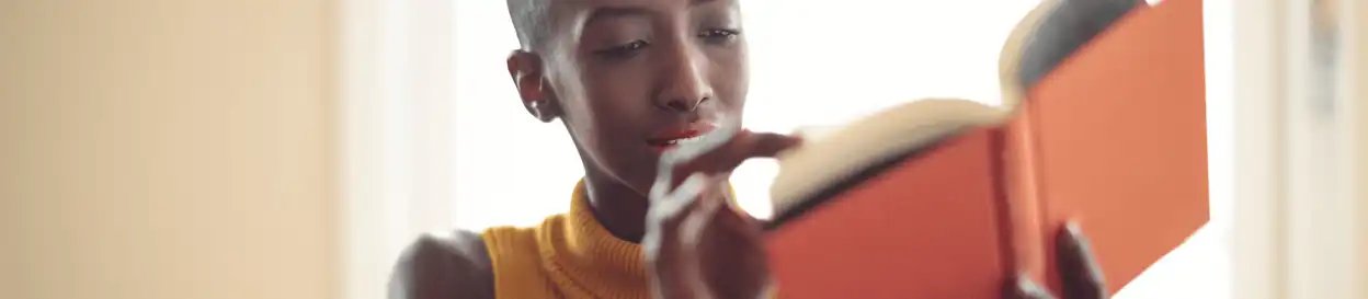 A woman reading a hardback book