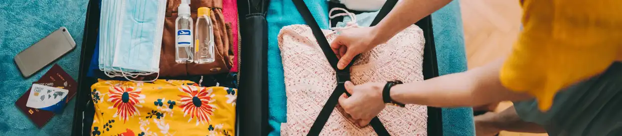 A woman packing a suitcase