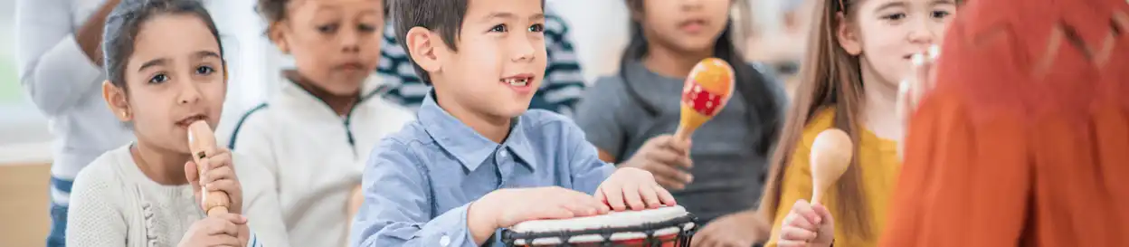 Young children in a classroom with instruments