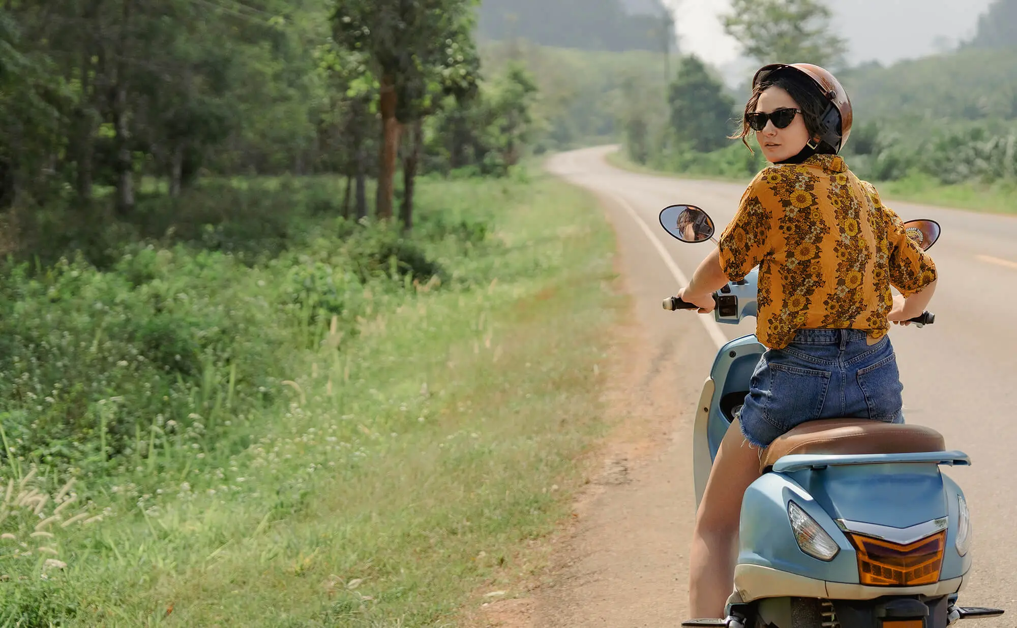 Woman on motrobike travelling in Asia